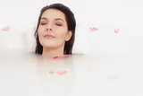 Blissful woman soaking in a hot bath