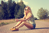 Trendy Hipster Girl Sitting on the Road