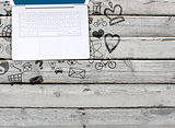 Laptop on an old wooden surface and social icons