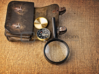 Vintage background with  wallet, compass and magnifier