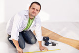 Man preparing to lay some laminate floor planks
