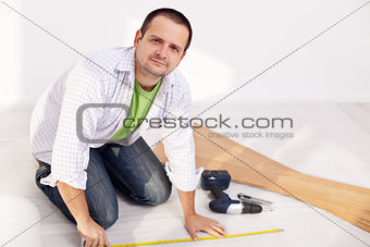 Man preparing to lay some laminate floor planks