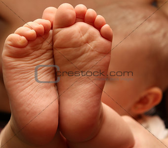 A closeup of tiny baby feet