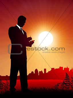 businessman at work on sunset background