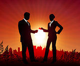 Businessman and Businesswoman on sunset background