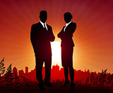 Businessman and Businesswoman on sunset background