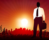 Businessman on sunset background with skyline