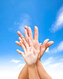 family united hands with blue sky and cloud 
