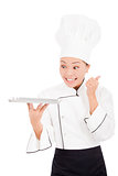 smiling female chef, cook or baker  showing thumbs up