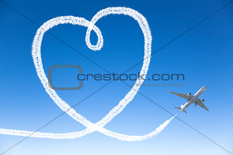 Airplane flying with the heart shape in the sky