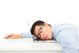Tired overworked businessman sleeps on laptop