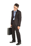 overwork and exhausted businessman holding briefcase