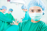 Surgical woman and Surgeons  in an  operating theater