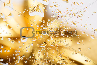 golden abstract background with water drops