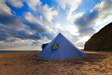 Conical tent on summer beach and blue sky with clouds