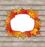 Autumn label with leaves maple, wooden texture