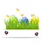 Easter colorful eggs in green grass with space for your text