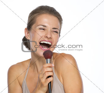 Happy young woman singing in brush