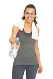 Fitness young woman giving bottle of water
