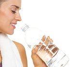 Closeup on fitness young woman drinking water