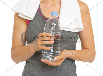 Closeup on fitness young woman with bottle of water