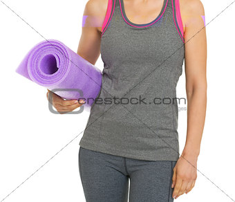 Closeup on fitness young woman with fitness mat
