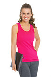 Portrait of smiling fitness young woman with clipboard