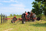 Tractor in Field with Hay Rake