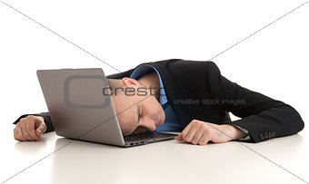 stressed businessman sleeping on a laptop