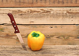 paprika and knife on wooden cutting board