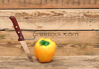paprika and knife on wooden cutting board