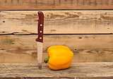 paprika and knife on wooden background