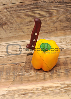 paprika and knife on wooden background