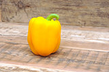 Yellow paprika on wooden background