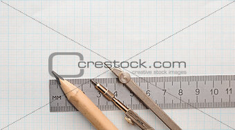 Still life photo of engineering graph paper with pencil, compass