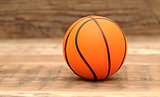Toy basketball on wood background
