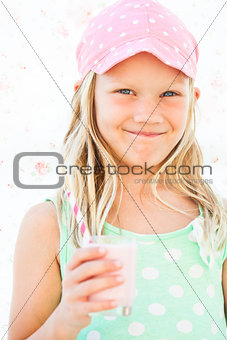 Smiling young girl holding smoothie drink