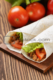 burritos with beef tomato and salad leaf