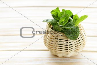 bunch of fresh green mint on white wooden table