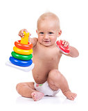 Cute little boy playing with pyramid toy over white background