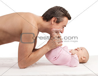 Young Caucasian father leaning over newborn son