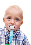 Closeup of cute blonde blue-eyed little boy with a pacifier