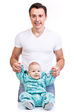 Young Caucasian father with baby son over white