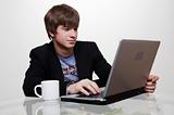confident young manager at work with laptop