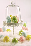 Cake stand with easter eggs and feathers