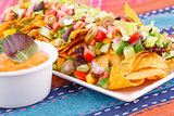 Nachos, vegetables and cheese sauce