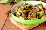 fried champignon mushrooms with thyme in a pan