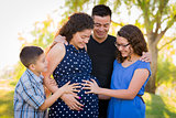 Hispanic Family Hands on Pregnant Mother Tummy Feeling Baby Kick