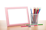 Blank photo frame and colorful pencils