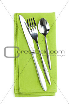 Silverware or flatware set of fork, spoon and knife on towel
